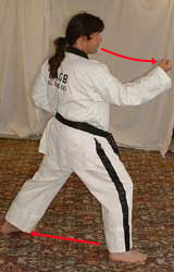 10) Move left leg diagonally out and turn 90° to the right hip-twisting into a right walking stance towards A whilst performing a right middle block