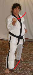 12) Move left leg diagonally out and turn 90° to the right hip-twisting into a right walking stance towards C whilst performing a right middle block