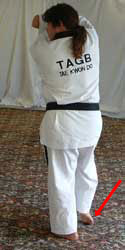 Turn head to look left towards B, pull front (right) foot back, raise arms to chamber position (facing outwards) with left arm on the inside (facing inwards)