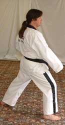 10) Turn 90° to the right hip-twisting into a right walking stance towards A whilst performing a right low block