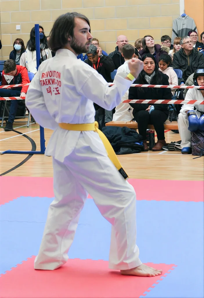 A student at a competition shows the white Revolution Taekwon Do Dobok.
