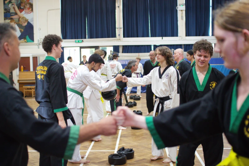 Students fist bump in a row